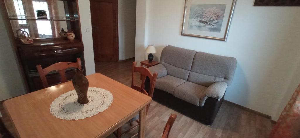 a living room with a couch and a table at Apartamento junto al Peñon de Ifach con parking in Calpe