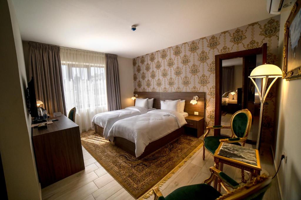 a hotel room with a bed and a living room with at Khan Khediwe Hotel in Amman