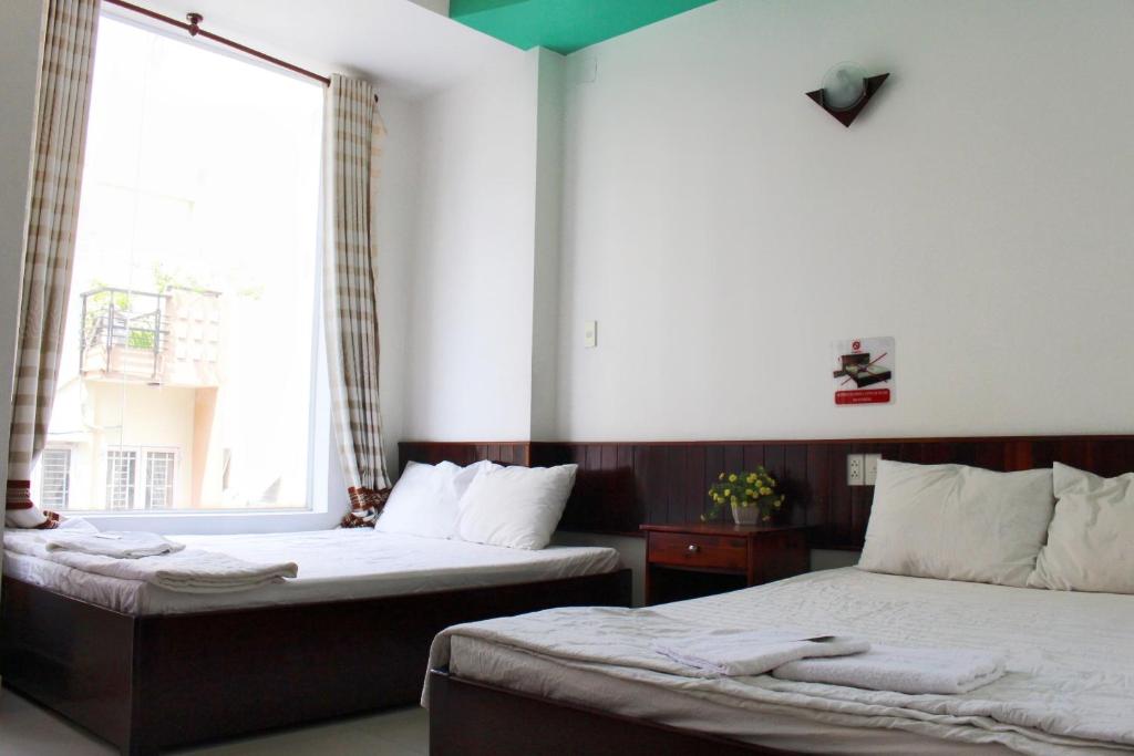 Postel nebo postele na pokoji v ubytování Mai Guest House