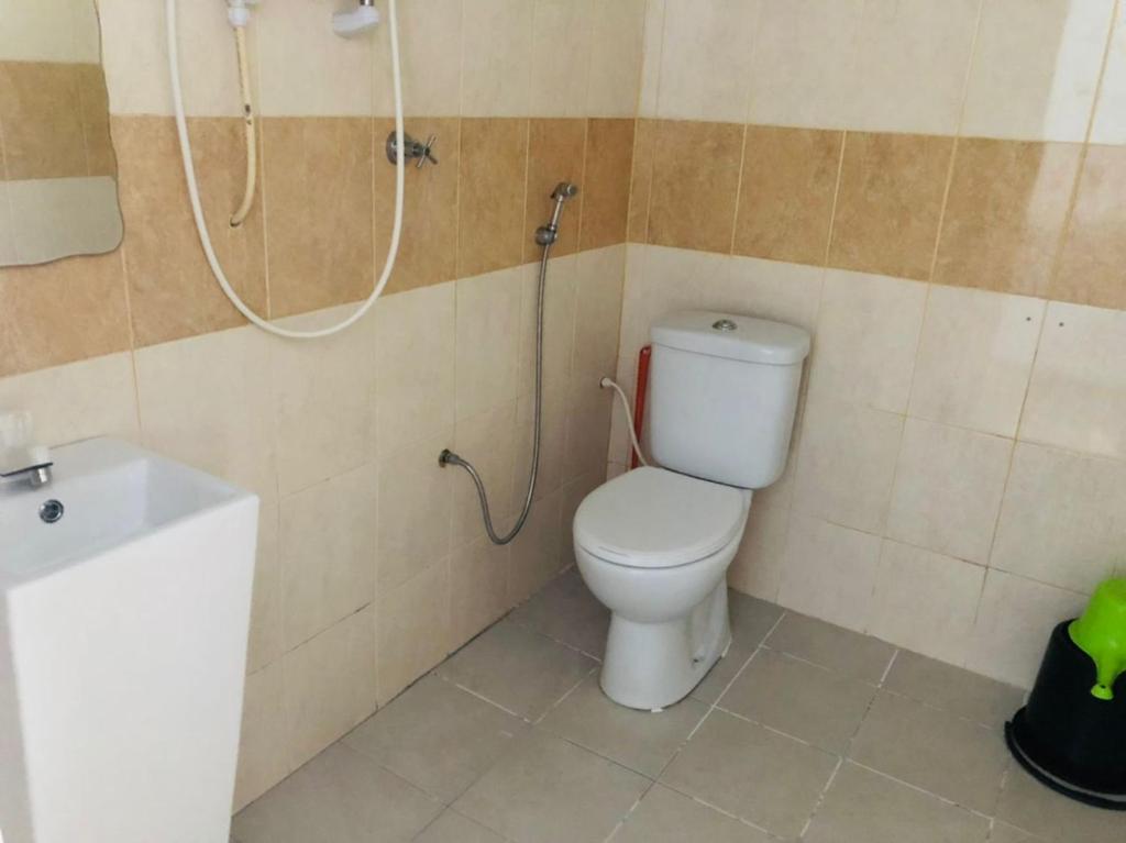 a bathroom with a toilet and a shower at Suhaila Palace in Perhentian Islands