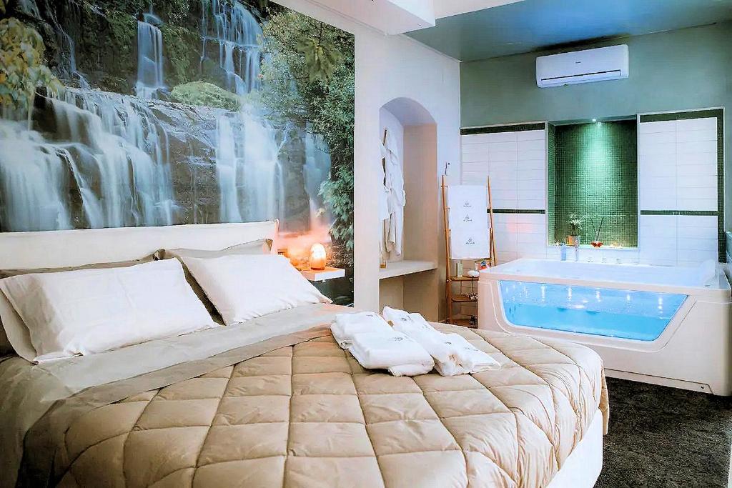 a bedroom with a large bed with a bath tub at Le coccole luxury Suite in Sannicandro di Bari