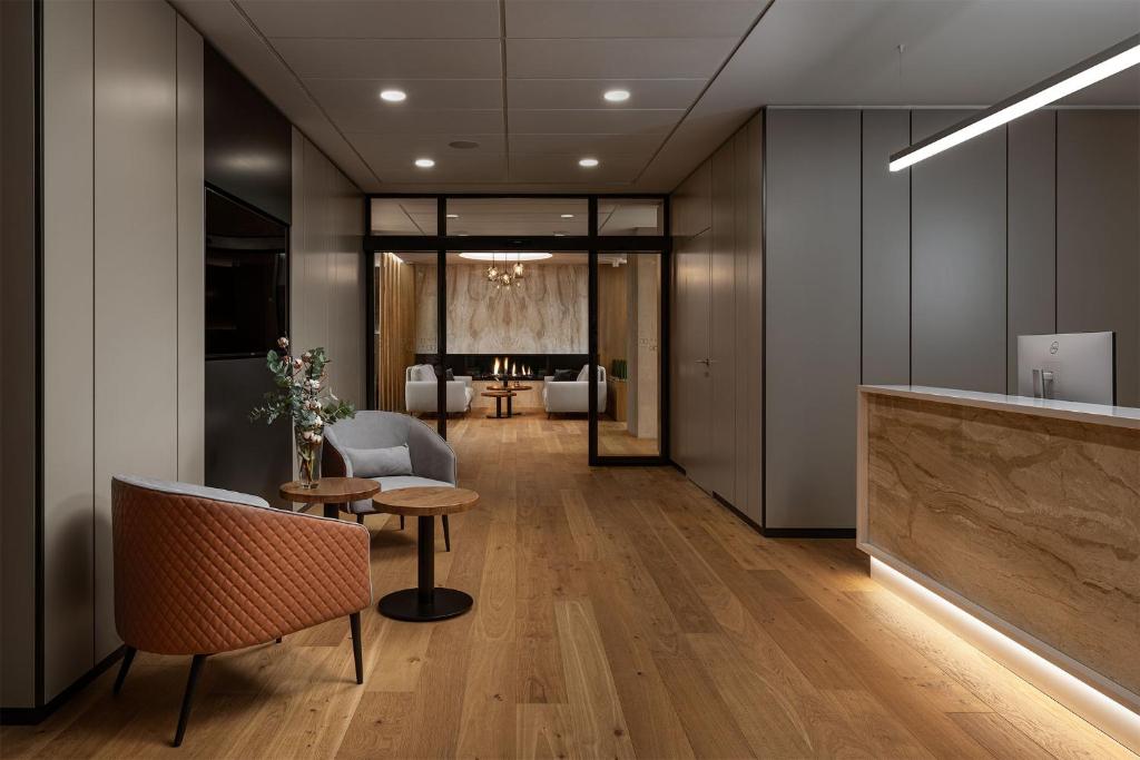 an office lobby with a table and chairs at Hotel Osvit in Mladá Boleslav