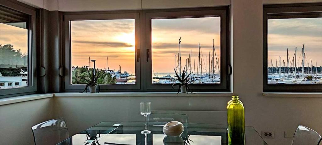 a dining room with a table and a view of a harbor at NOVIGRAD BOUTIQUE APARTMENT in Novigrad Istria