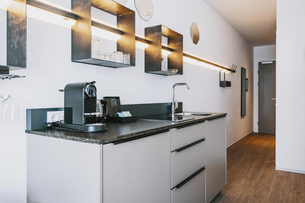 A kitchen or kitchenette at Nikolaus by AvenidA Panoramic Wellness Suites