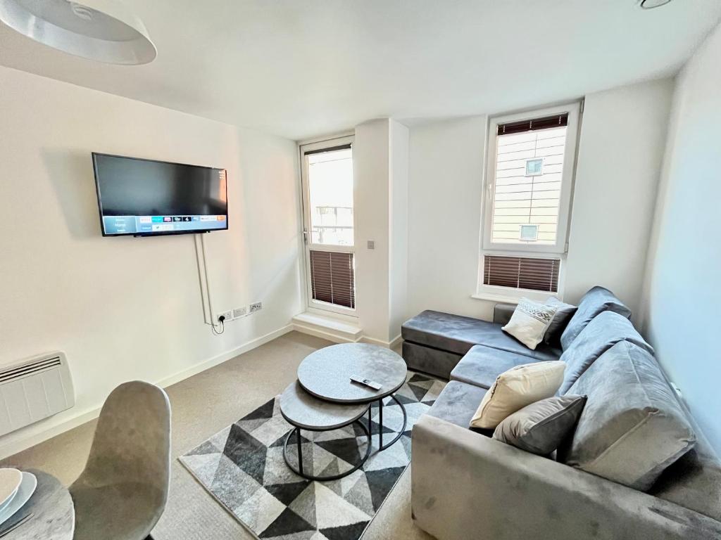 uma sala de estar com um sofá e uma mesa em 2 Bedroom, 2 Bathroom Modern Apartment close to Ocean Village, Free parking, Single or Double beds em Southampton
