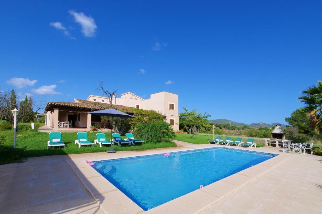 a villa with a swimming pool and a house at Finca Port Vert in Son Servera