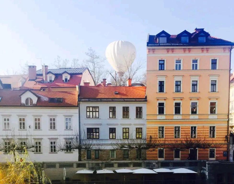 a hot air balloon flying over a building at Apartment in the heart of Ljubljana in Ljubljana