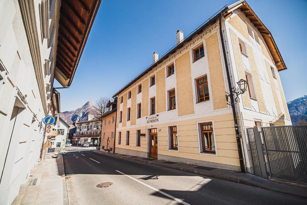 an empty street in a town with buildings at Apartments Rombon Klavdij with Free Onsite Parking in Bovec
