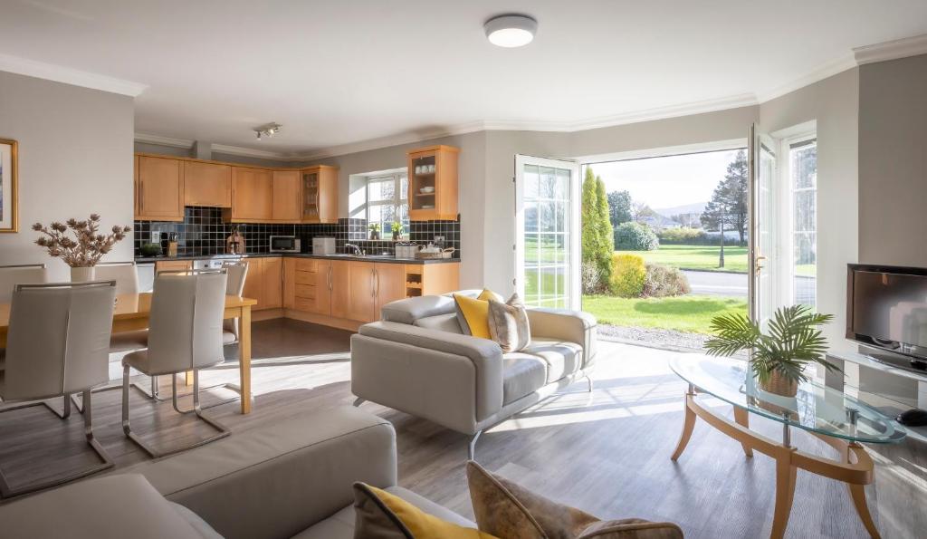 a living room with a couch and a table at The Gleneagle River Apartments in Killarney