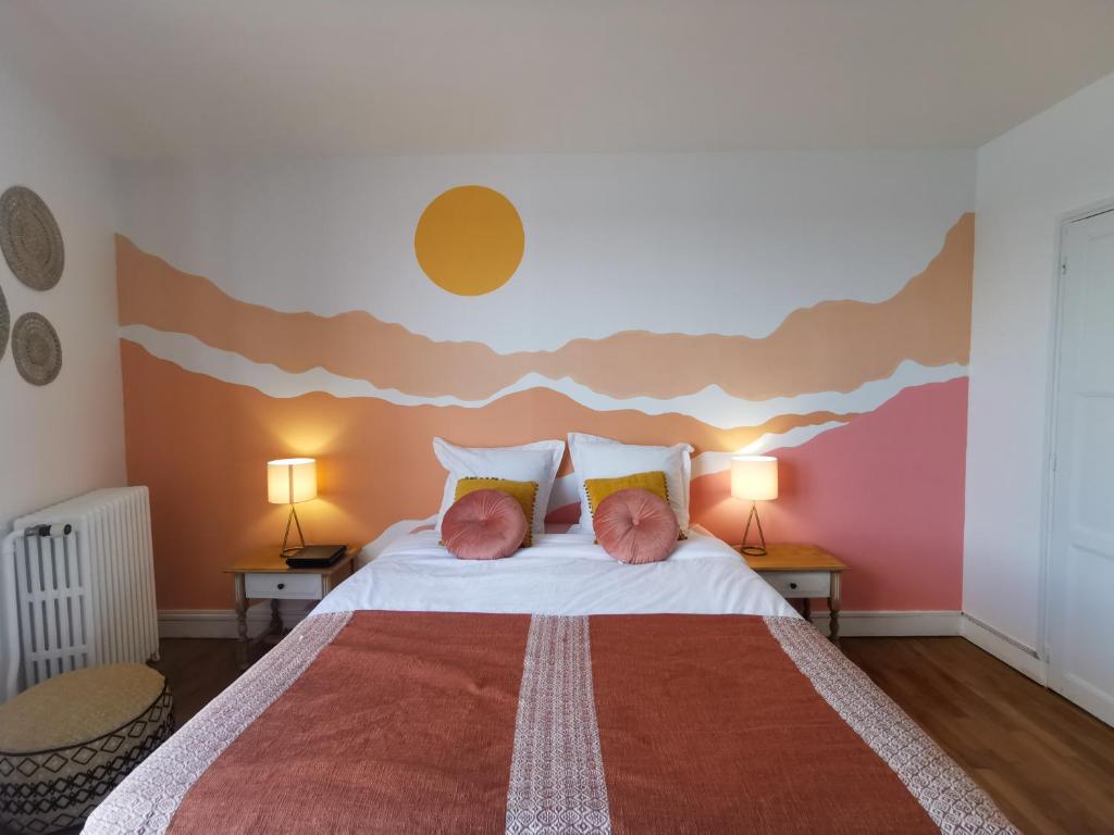 a bedroom with a large bed with two pillows at Les Rauches - Quai Loire - Suite 2 Chambres in Châteauneuf-sur-Loire