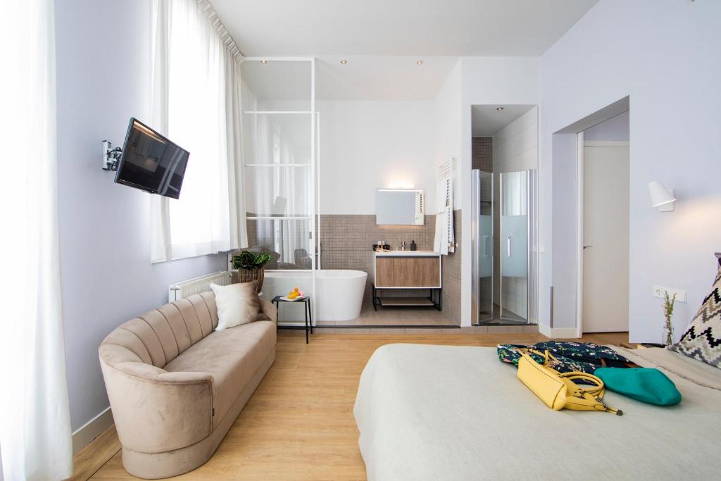 Postel nebo postele na pokoji v ubytování Stadsvilla Hotel Mozaic Den Haag