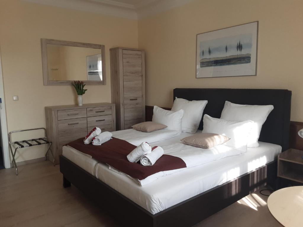 a bedroom with a large bed with towels on it at Pension Celia in Wismar