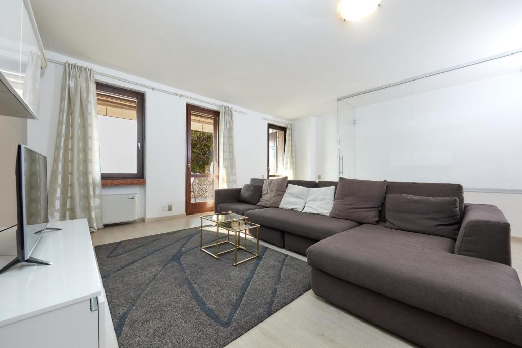 a living room with a couch and a television at Lake Front Casa Christina in Malcesine