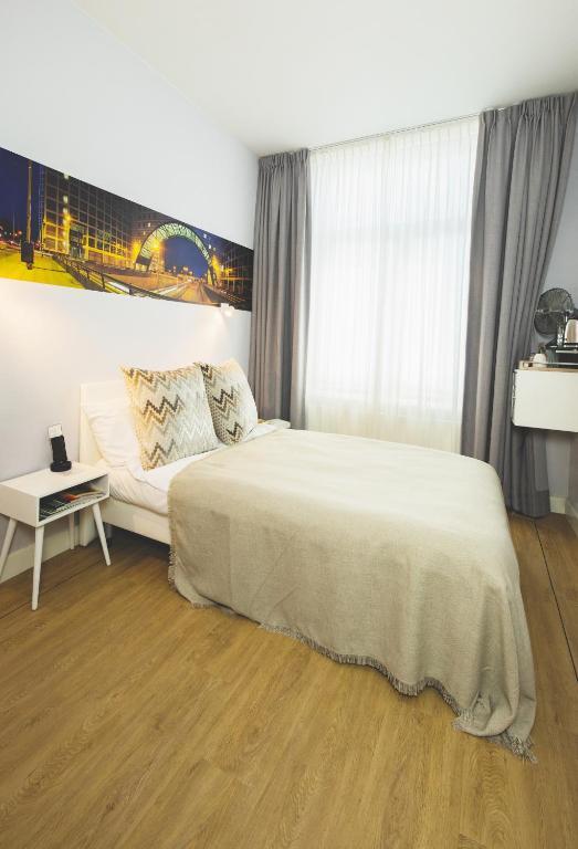 Postel nebo postele na pokoji v ubytování Stadsvilla Hotel Mozaic Den Haag
