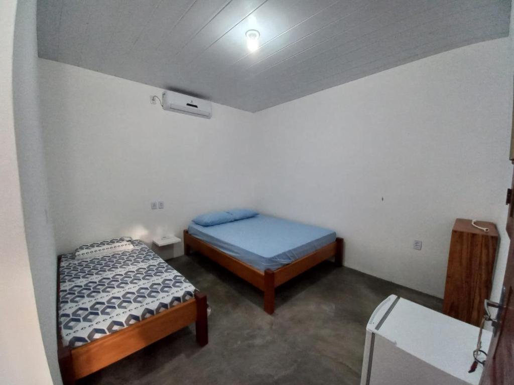 una camera con due letti in una stanza con soffitto di POUSADA DO BETO ad Atins