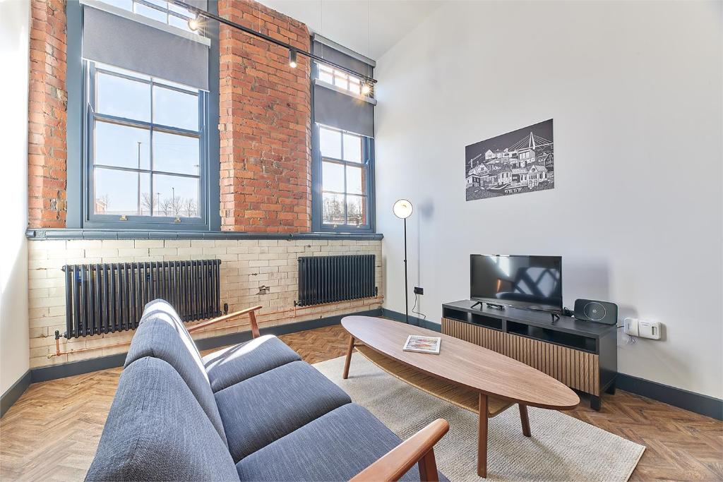 a living room with a couch and a table at No 2 at Simpson Street Apartments Sunderland in Sunderland