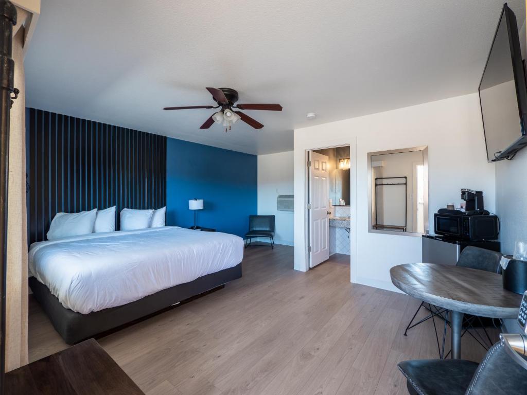 a bedroom with a bed and a ceiling fan at Balanced Rock Inn in Fruita