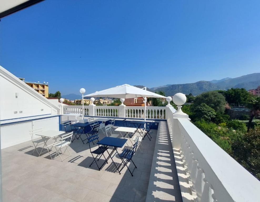 a view of a balcony with chairs and tables at Villa Gabriella - Rooms & Breakfast in Sant'Agnello