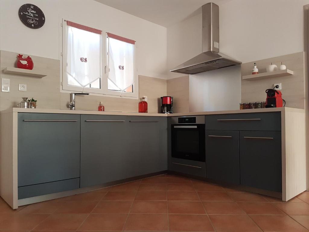 a kitchen with a sink and a stove at Les oliviers de Murateddu (Maison individuelle) in Porto-Vecchio