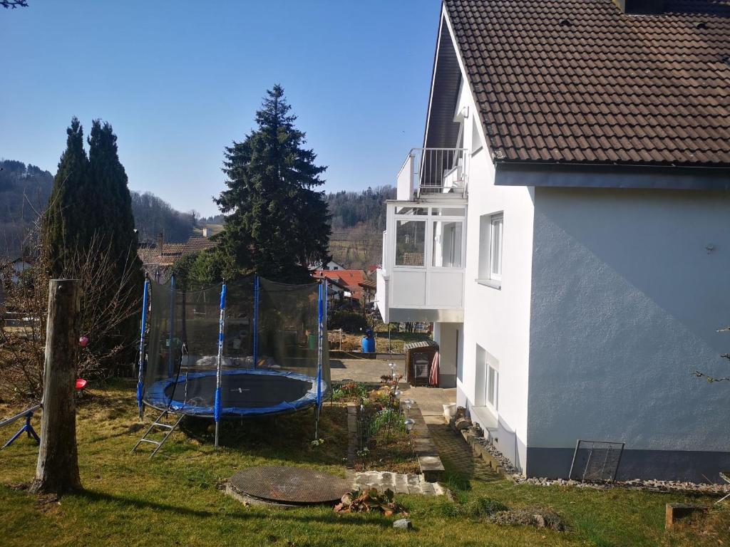 a house with a swimming pool next to a house at Ferienwohnung Dinkelbergblick Öflingen in Wehr