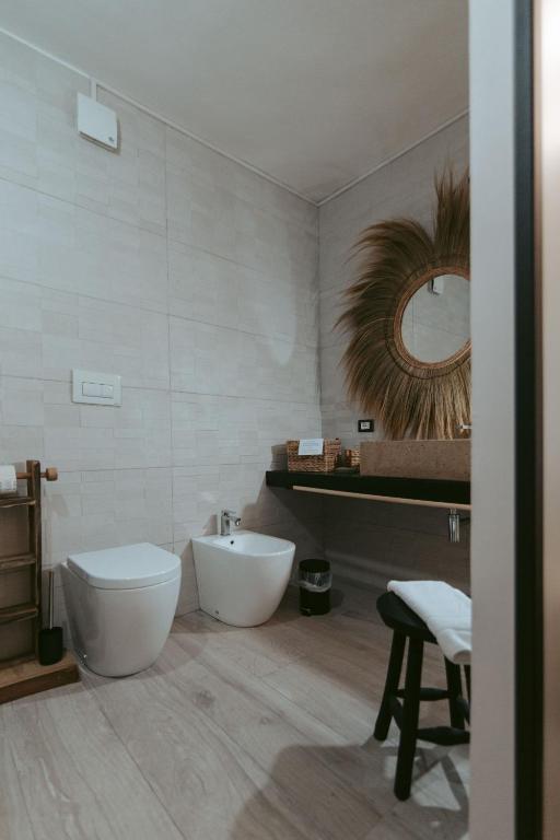 a bathroom with a toilet and a sink and a mirror at Laguna Suite B&B in Chioggia