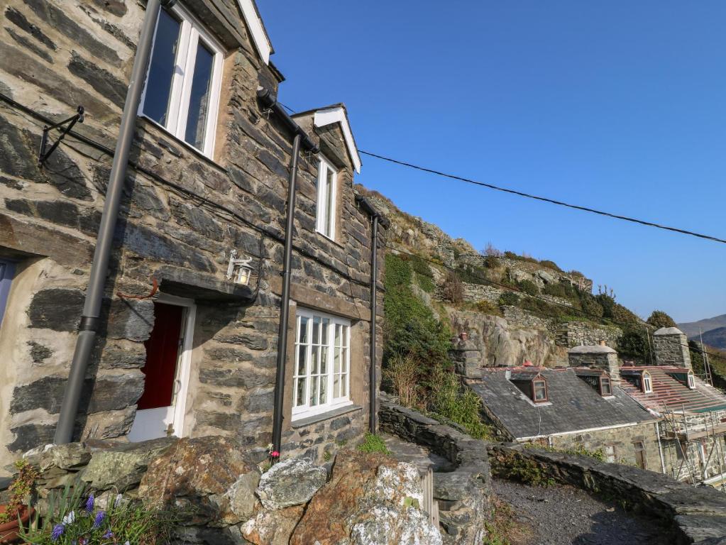 an old stone house on the side of a hill at 2 Bwth Mawr in Barmouth