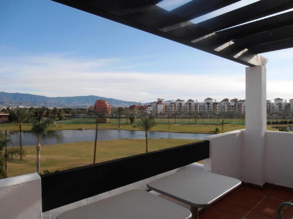 a balcony with a view of a river and buildings at Playa Golf in Motril