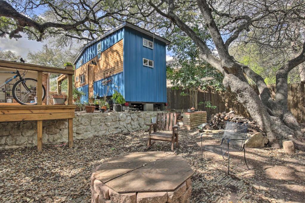a blue house with a bench and a tree at Unique Stay Tiny Everest San Antonio Home! in San Antonio