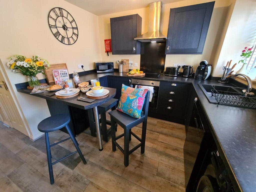 a kitchen with a small table and a counter top at The Shambles by Spires Accommodation A Boho styled place to stay just 3 miles from Birches Valley visitors Centre Cannock Chase in Rugeley