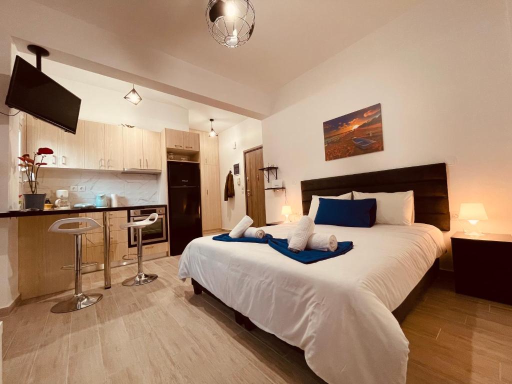 a bedroom with a large bed and a kitchen at Diamond Apartment in Athens