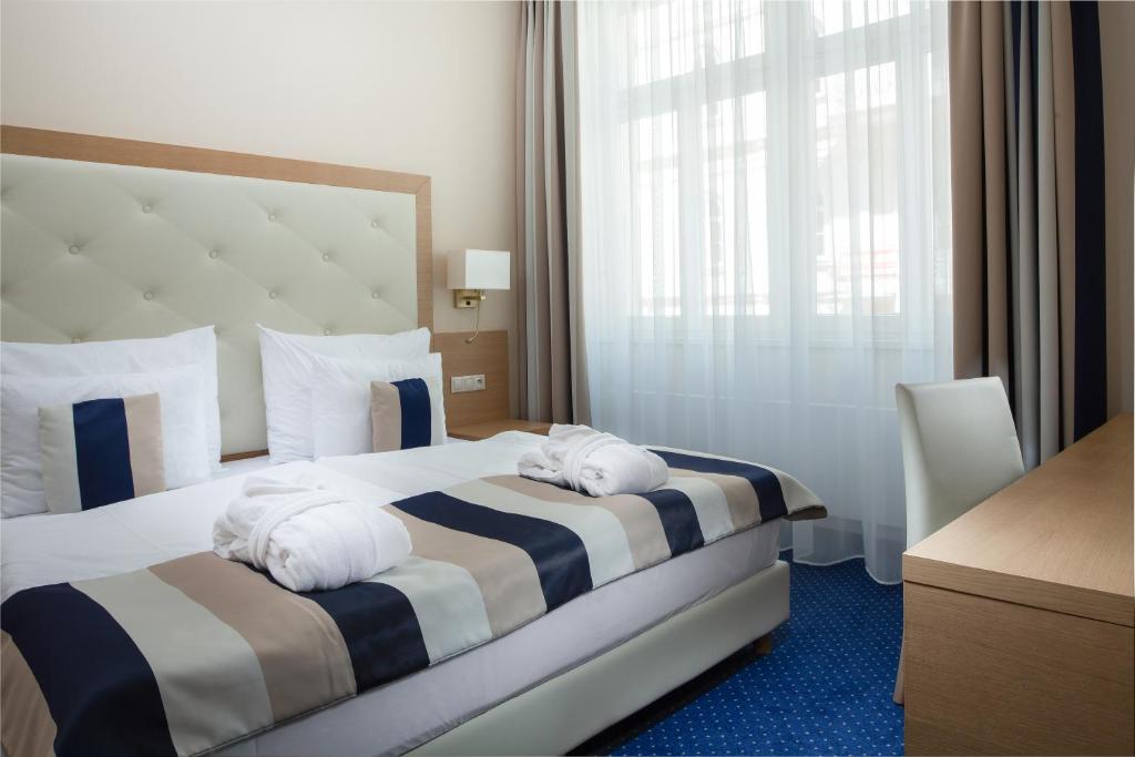 Postel nebo postele na pokoji v ubytování Grandhotel Nabokov