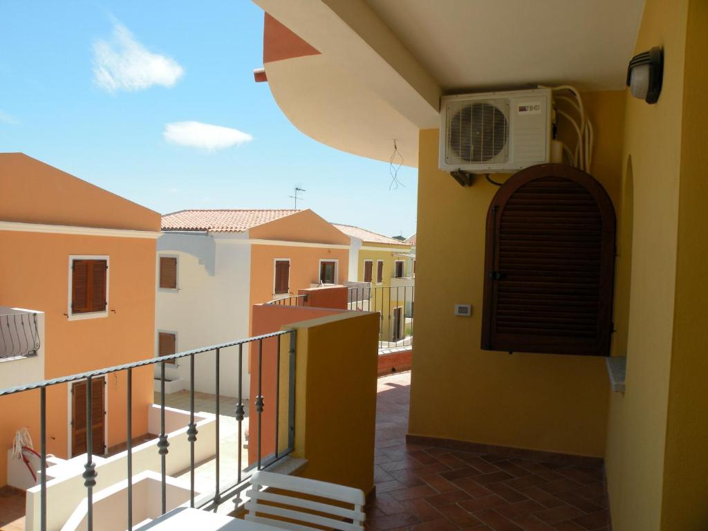 a balcony with a fan on the side of a building at Appartamento residence casa vacanza in Santa Teresa Gallura