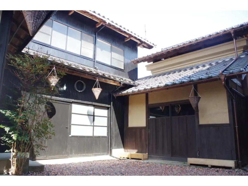 a house with a garage and two hanging baskets at base sanablend - Vacation STAY 37411v in Kyotango