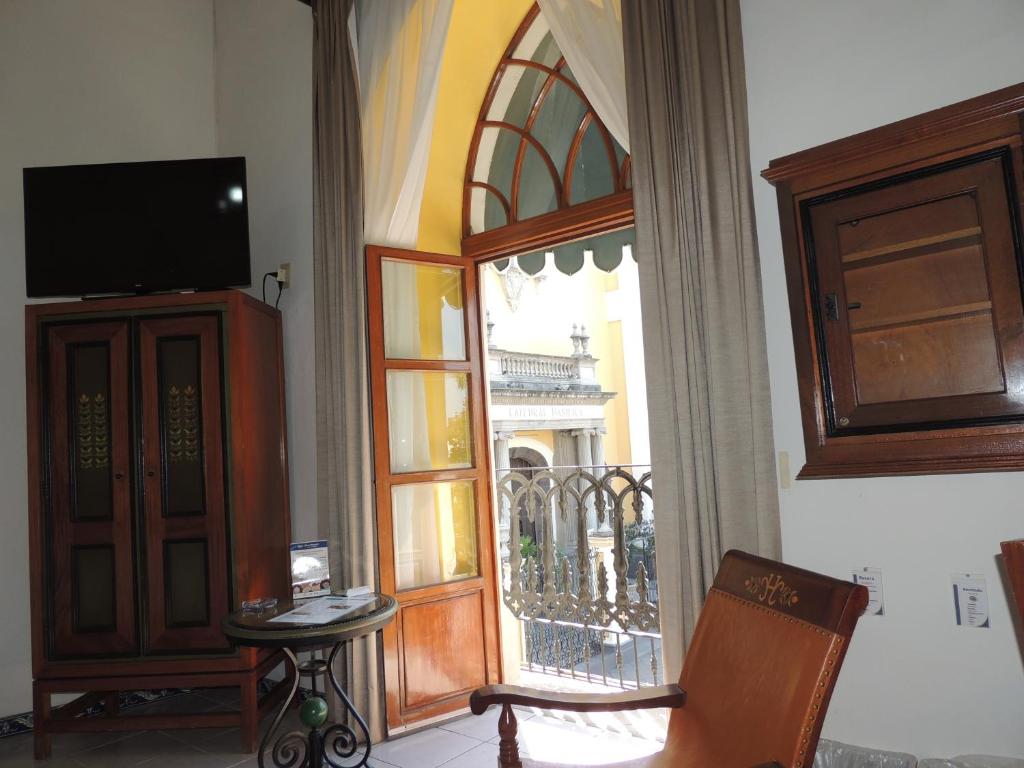 a room with a door open to a balcony at Hotel Concierge Plaza Colima in Colima