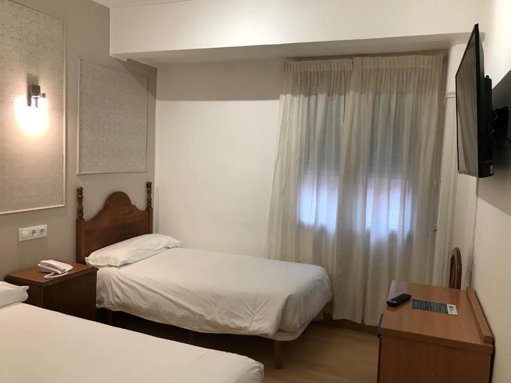 Postel nebo postele na pokoji v ubytování Hostal La Mexicana