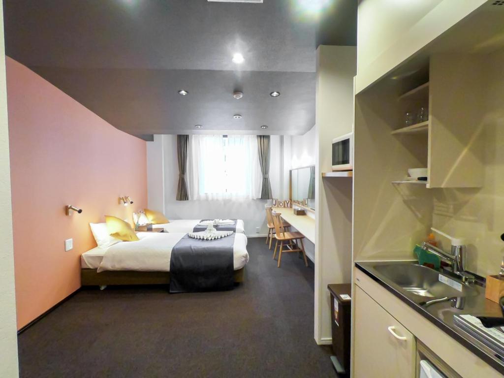 a hotel room with a bed and a sink in it at Hotel S-Presso Central - Vacation STAY 9444 in Osaka