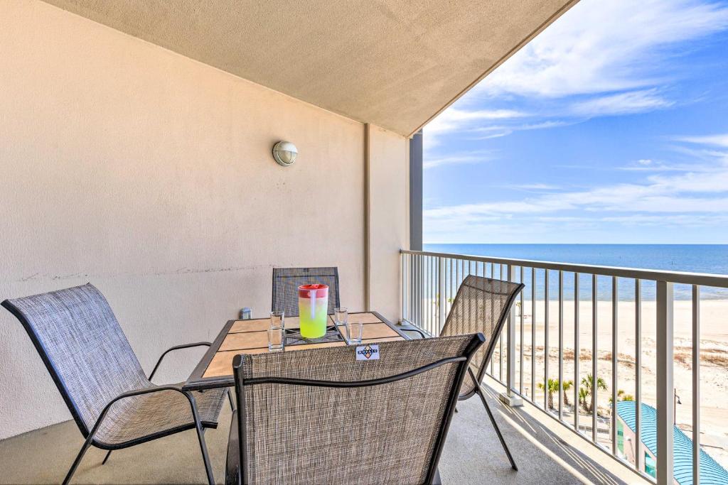 a balcony with a table and chairs and the ocean at Spacious Biloxi Getaway with Pools and Beach Access! in Biloxi