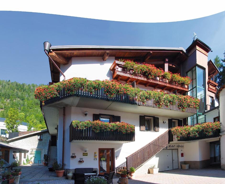 a building with flower boxes on the side of it at Albergo Aprica Garni in Aprica