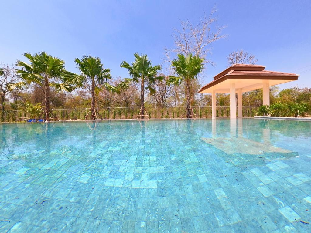 a large swimming pool with a gazebo at Isan Golf & Adventure Hotel in Udon Thani