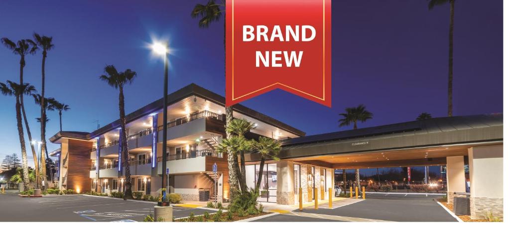 a large building with a sign that reads brand new at Studio 6 Suites Stockton, CA Waterfront in Stockton