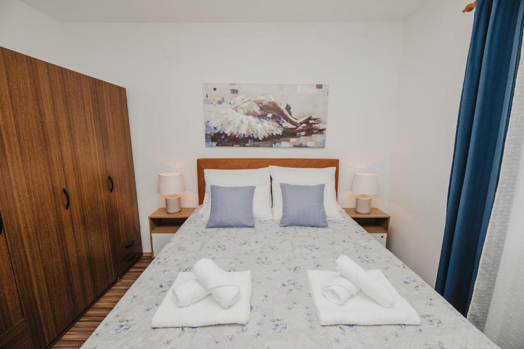 a bedroom with a bed with two pillows on it at Apartman Branko in Zaboric