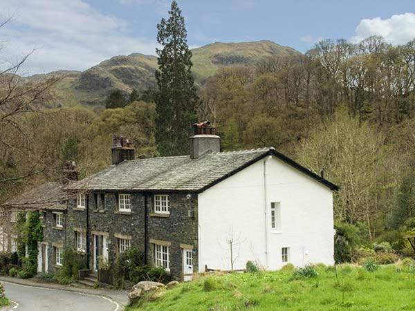 a large house on a hill in a field at Littlebeck in Rosthwaite