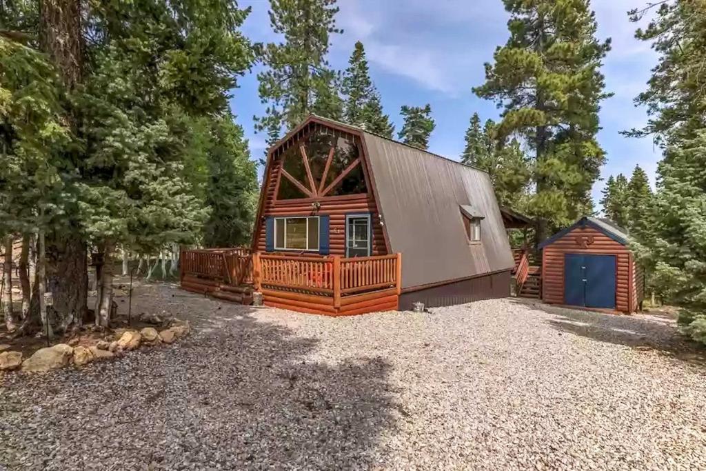 a cabin in the woods with a gravel yard at Unique Forest Cabin with Deck Ski, Hike, Fish! in Duck Creek Village