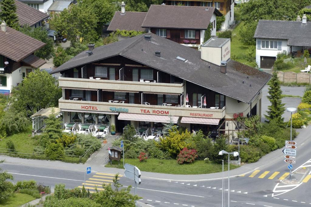 a large building on the side of a street at Hotel Walida in Bönigen
