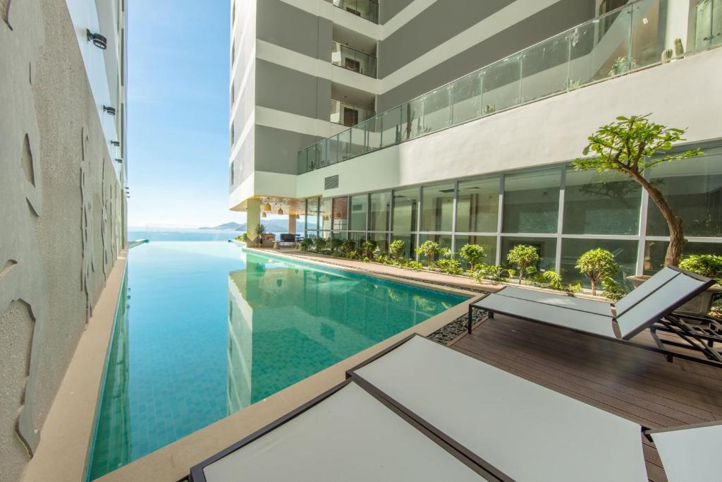 a swimming pool in the middle of a building at Handy Panorama Nha Trang Ocean view by HDG in Nha Trang