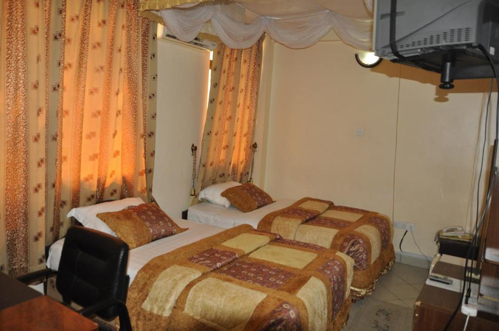 Postel nebo postele na pokoji v ubytování Rich Hotel