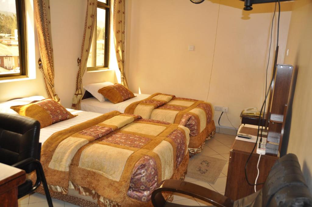 Postel nebo postele na pokoji v ubytování Rich Hotel