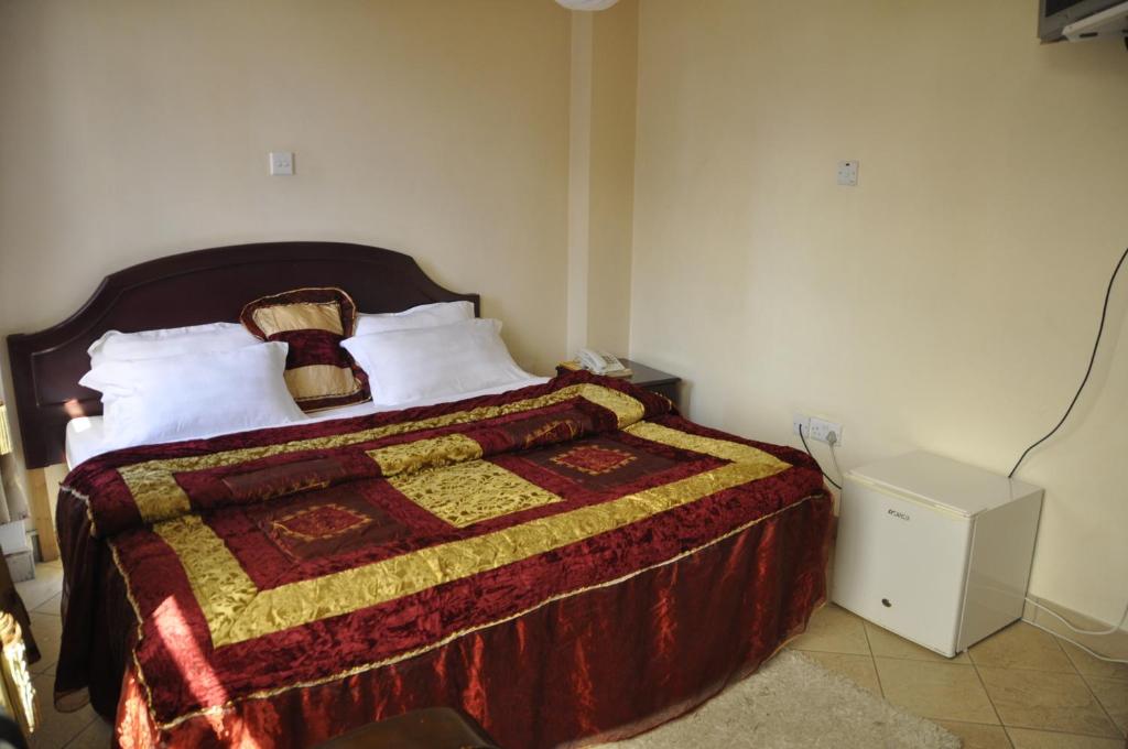 Postel nebo postele na pokoji v ubytování Rich Hotel
