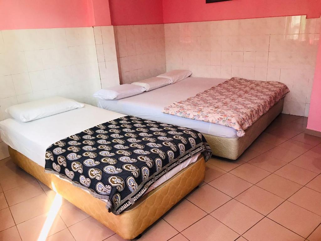 Postel nebo postele na pokoji v ubytování Hotel Cahaya