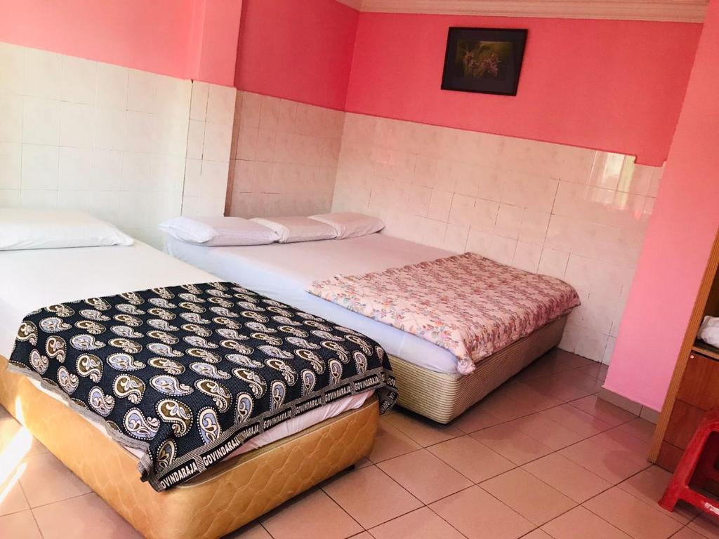 Postel nebo postele na pokoji v ubytování Hotel Cahaya